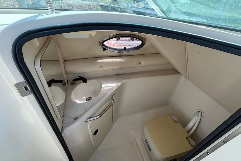 Slide: The Image of Interior of 2001 Sea Ray 240 Sundancer boat bathroom with sink and toilet. - 20