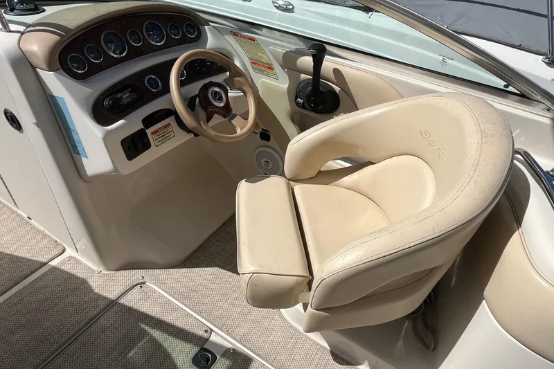 Slide: The Image of 2001 Sea Ray 240 Sundancer helm with beige captain's chair and control panel. - 22