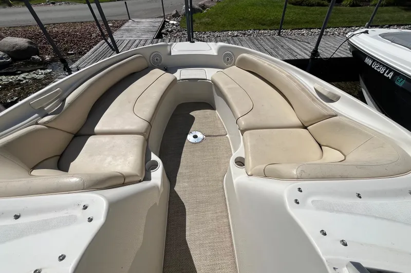 Slide: The Image of 2001 Sea Ray 240 Sundancer boat interior with beige seating and carpeted floor. - 27