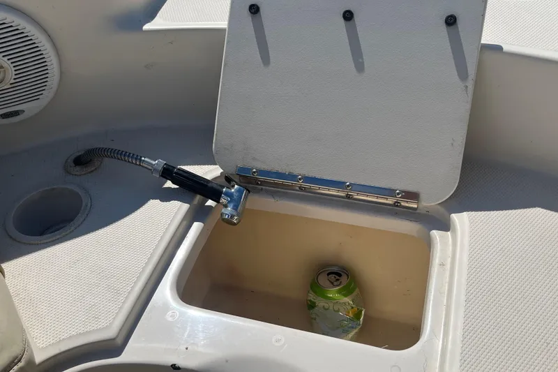 Slide: The Image of Open storage compartment on 2001 Sea Ray 240 Sundancer boat with beverage can inside. - 28