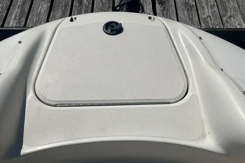 Slide: The Image of 2001 Sea Ray 240 Sundancer boat deck with textured surface and hatch. - 29