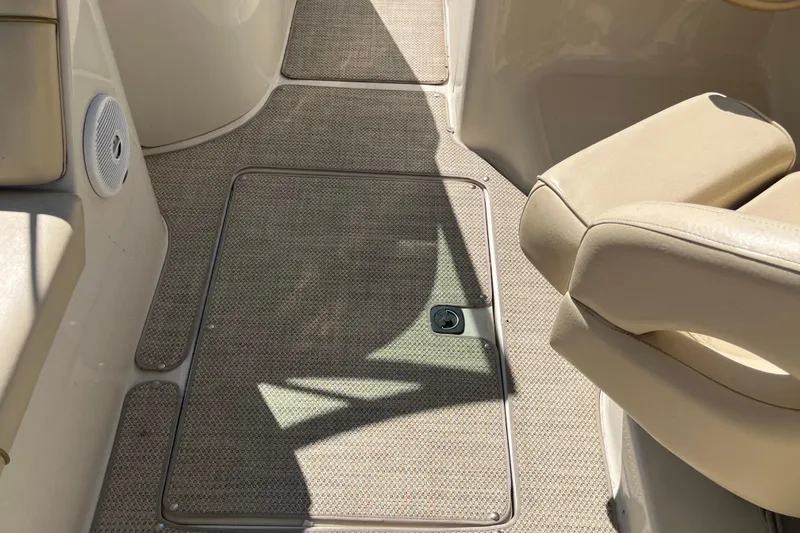 Slide: The Image of Interior of 2001 Sea Ray 240 Sundancer boat with beige seating and carpeted floor. - 32