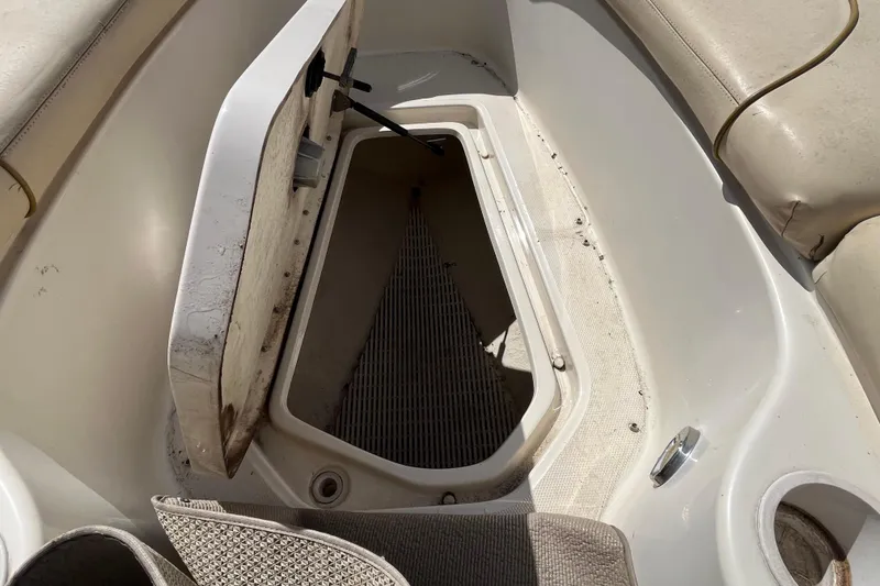 Slide: The Image of Open storage compartment on a 2001 Sea Ray 240 Sundancer boat. - 34