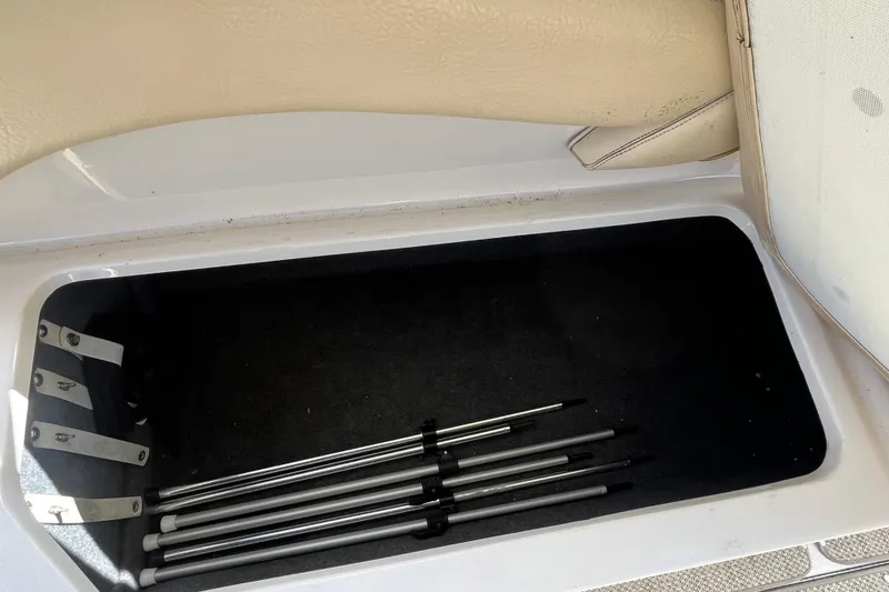 Slide: The Image of Storage compartment in a 2001 Sea Ray 240 Sundancer boat with metal rods inside. - 7