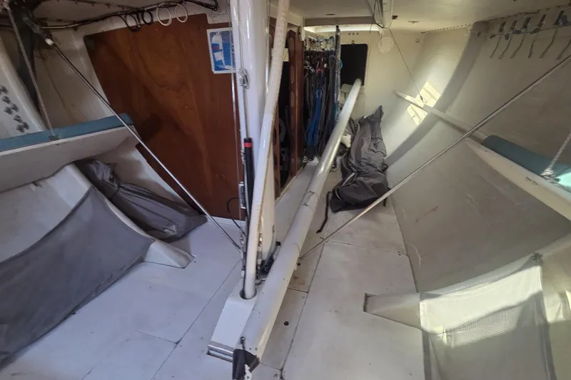 Slide: The Image of Interior of a 1986 Santa Cruz 70 sailboat, featuring storage and rigging elements. - 13