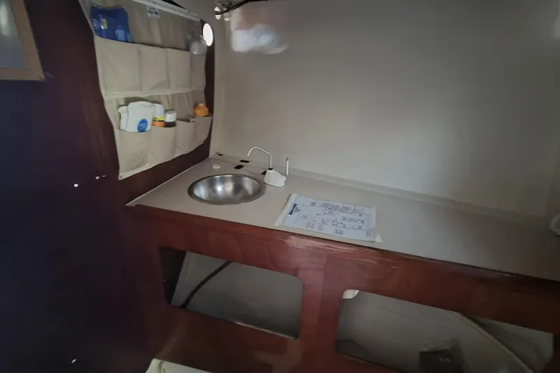 Slide: The Image of Interior of 1986 Santa Cruz 70 yacht with sink, storage pockets, and countertop. - 17