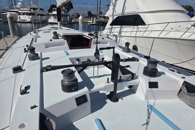 Slide: The Image of Sailboat deck of 1986 Santa Cruz 70, docked at marina with winches and rigging. - 19