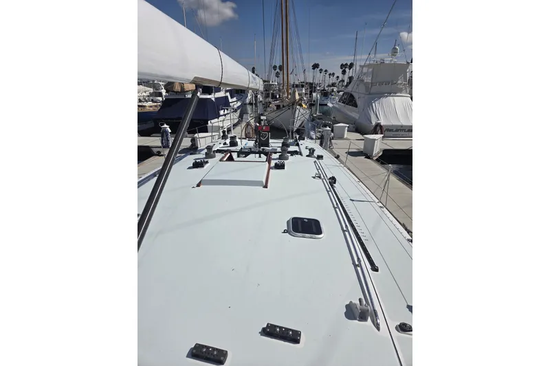 Slide: The Image of 1986 Santa Cruz 70 sailboat docked at marina, showcasing deck and rigging. - 23