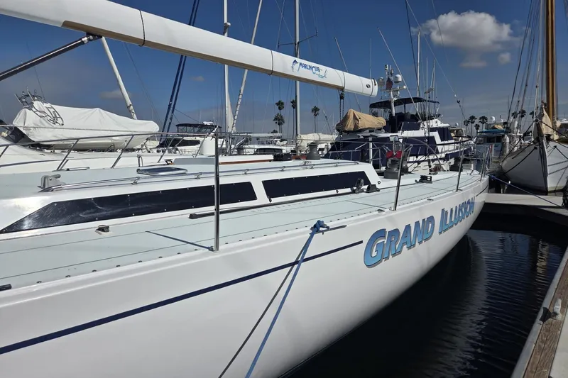 Slide: The Image of 1986 Santa Cruz 70 sailboat "Grand Illusion" docked at marina under clear blue sky. - 27