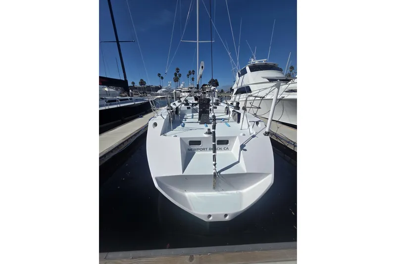 Slide: The Image of 1986 Santa Cruz 70 sailboat docked in Newport Beach marina, clear blue sky. - 28