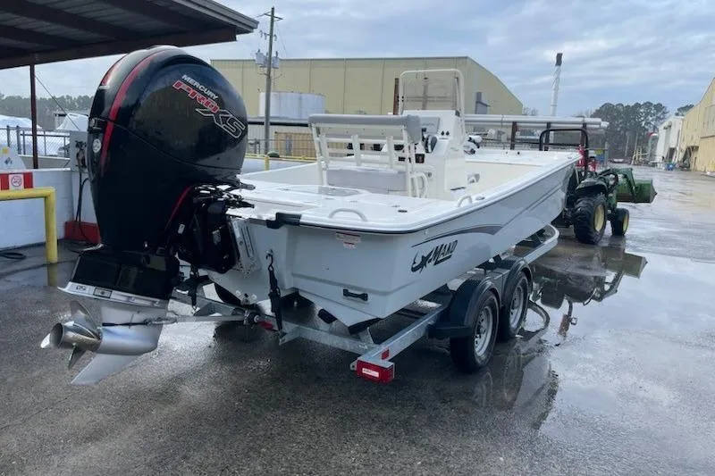 Slide: The Image of 2024 Mako Pro Skiff 19 CC boat on trailer with powerful outboard motor. - 11
