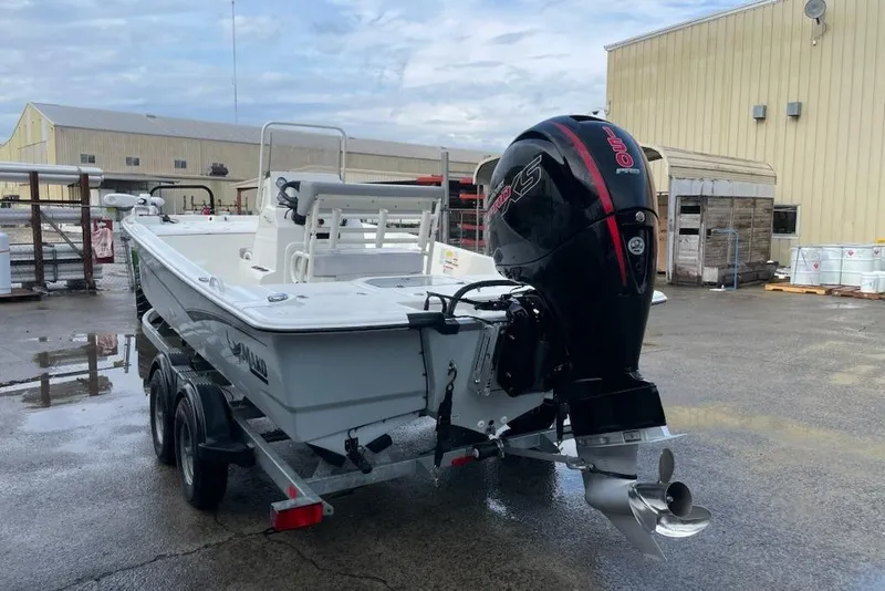 Slide: The Image of 2024 Mako Pro Skiff 19 CC boat with powerful outboard motor on trailer. - 12