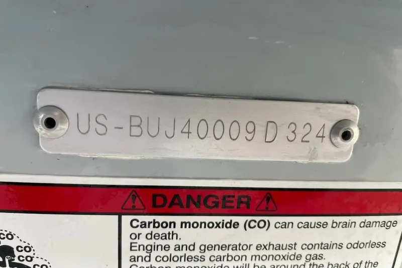 Slide: The Image of 2024 Mako Pro Skiff 19 CC hull identification number and carbon monoxide warning label. - 13