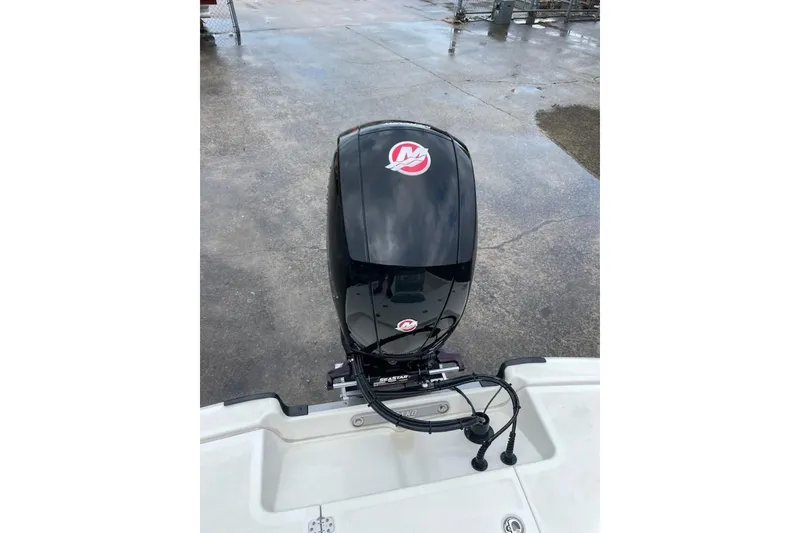 Slide: The Image of 2024 Mako Pro Skiff 19 CC boat with a powerful outboard motor. - 7