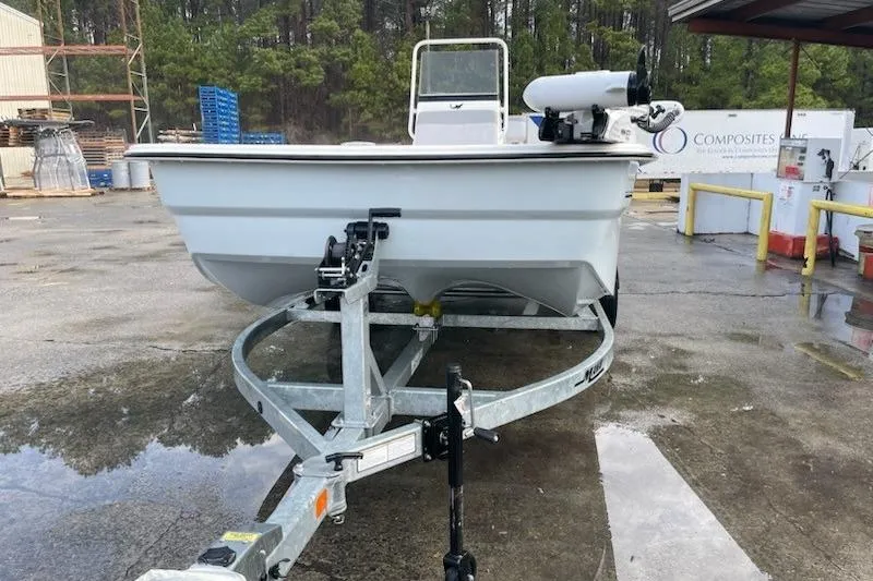 Slide: The Image of 2024 Mako Pro Skiff 19 CC on trailer in industrial setting. - 9