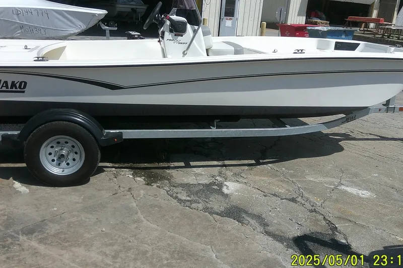 Slide: The Image of 2024 Mako Pro Skiff 17 CC boat on trailer, parked outdoors. - 2