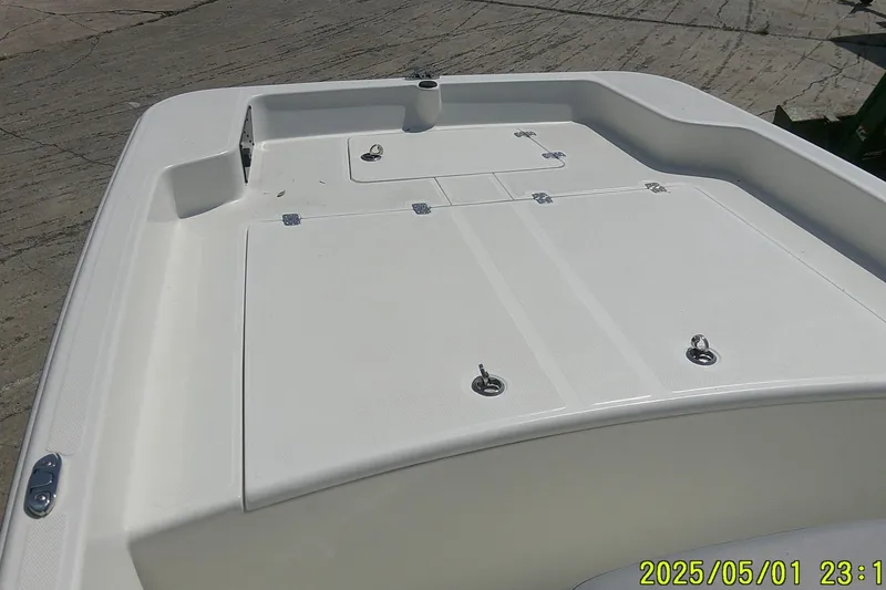 Slide: The Image of 2024 Mako Pro Skiff 17 CC boat deck, featuring storage compartments and sleek design. - 3