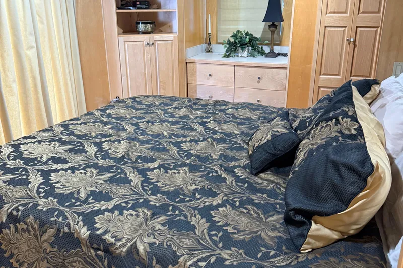 Slide: The Image of Luxurious bedroom interior on a 2002 Navigator houseboat with elegant floral bedding. - 10