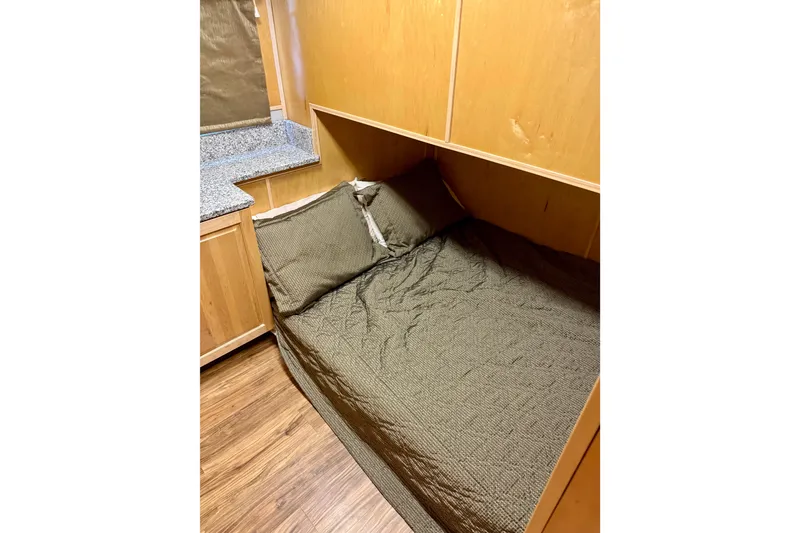 Slide: The Image of Cozy bedroom in 2002 Navigator houseboat with wooden interior and comfortable bedding. - 15