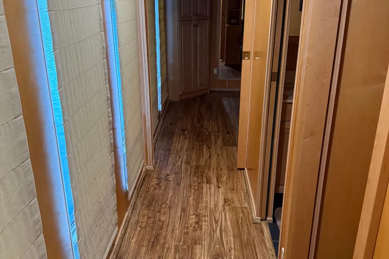 Slide: The Image of Interior hallway of a 2002 Navigator houseboat with wooden flooring and paneling. - 16