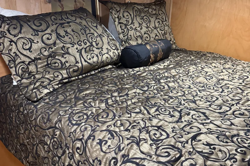 Slide: The Image of Luxurious bed with ornate bedding inside a 2002 Navigator houseboat cabin. - 17