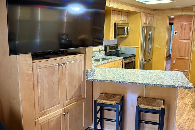 Slide: The Image of Interior of 2002 Navigator houseboat with modern kitchen and large TV. - 20