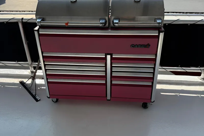 Slide: The Image of Red tool chest with multiple drawers on a 2002 Navigator houseboat deck. - 23
