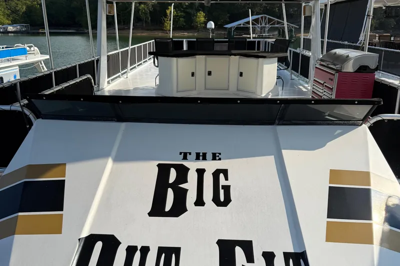Slide: The Image of 2002 Navigator houseboat with outdoor kitchen and "The Big Out Fit" text on deck. - 24
