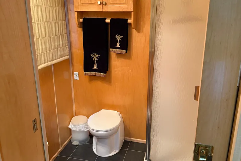 Slide: The Image of Bathroom interior of 2002 Navigator houseboat with palm tree towels and modern fixtures. - 7