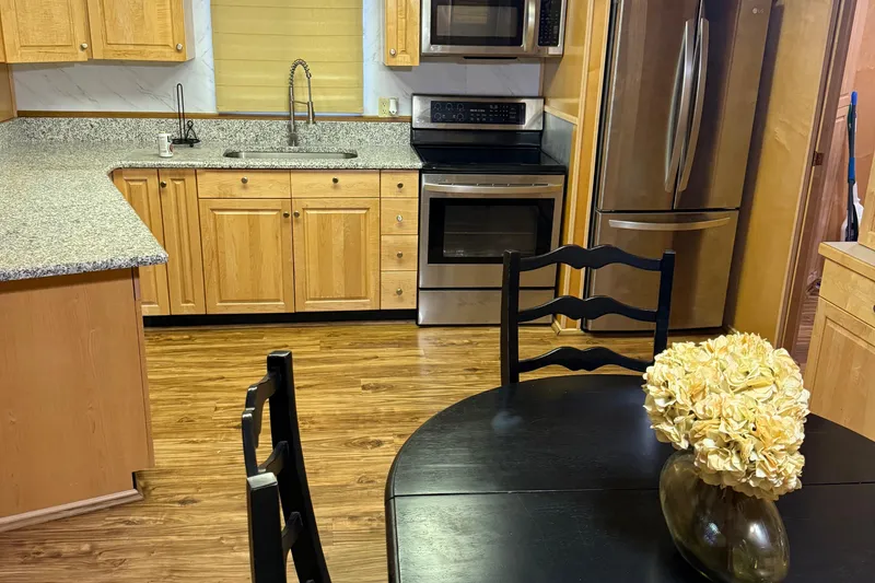 Slide: The Image of Modern kitchen in 2002 Navigator houseboat with wooden cabinets and stainless steel appliances. - 9