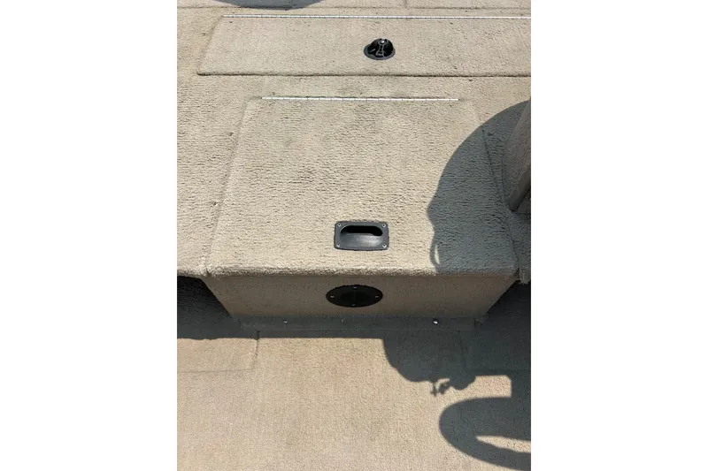 Slide: The Image of 2003 Crestliner 1850 Fish Hawk SC boat interior with carpeted deck and storage compartments. - 12