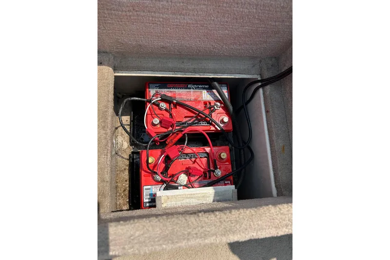 Slide: The Image of 2003 Crestliner 1850 Fish Hawk SC boat battery compartment with red Odyssey Extreme batteries. - 14