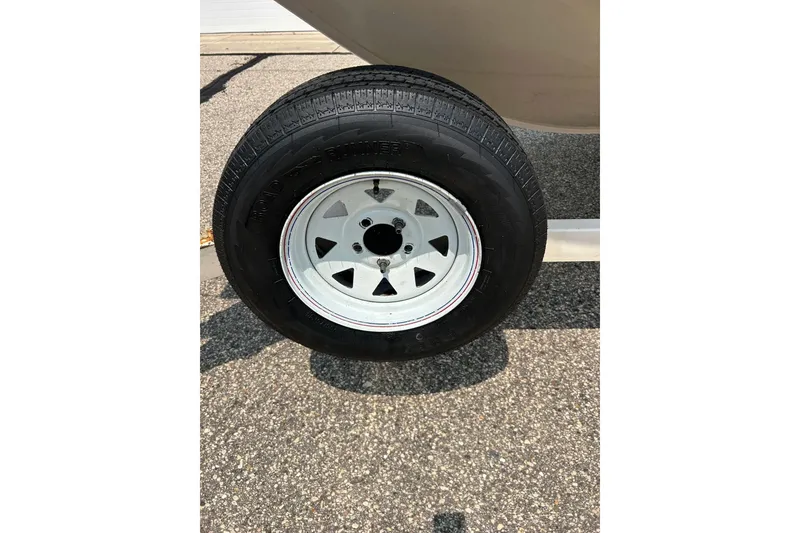 Slide: The Image of Trailer wheel of 2003 Crestliner 1850 Fish Hawk SC on pavement. - 23