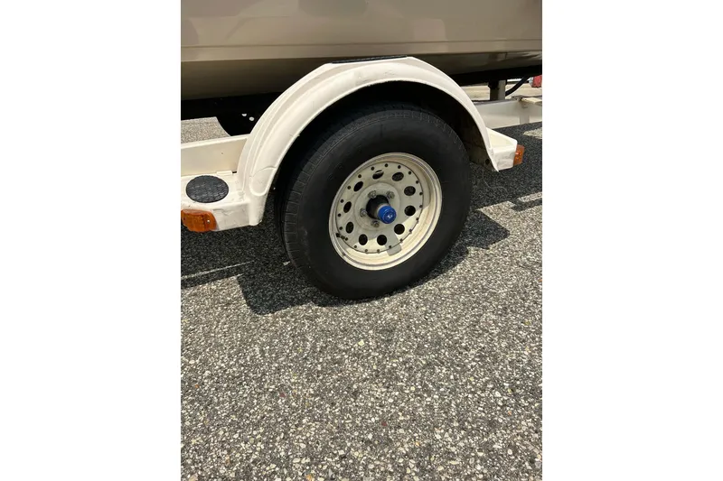 Slide: The Image of Trailer wheel of 2003 Crestliner 1850 Fish Hawk SC on asphalt surface. - 24