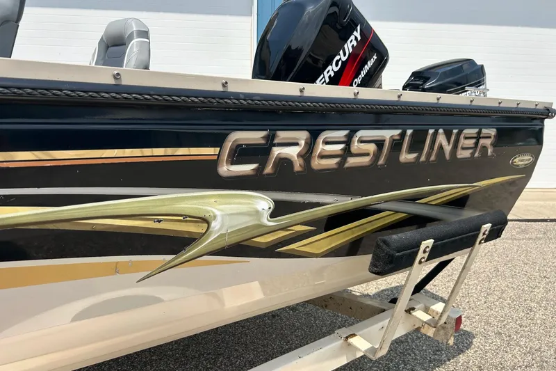 Slide: The Image of 2003 Crestliner 1850 Fish Hawk SC boat with Mercury OptiMax engine, side view. - 25