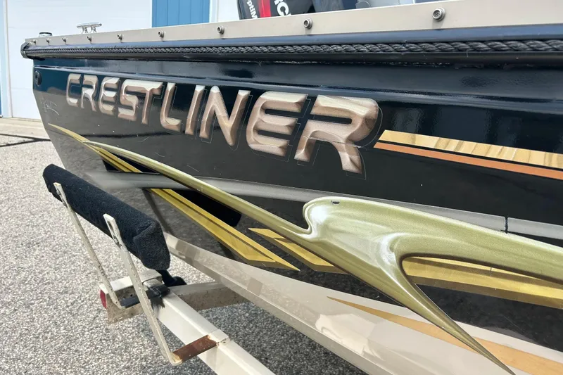 Slide: The Image of 2003 Crestliner 1850 Fish Hawk SC boat with bold graphics and logo. - 3