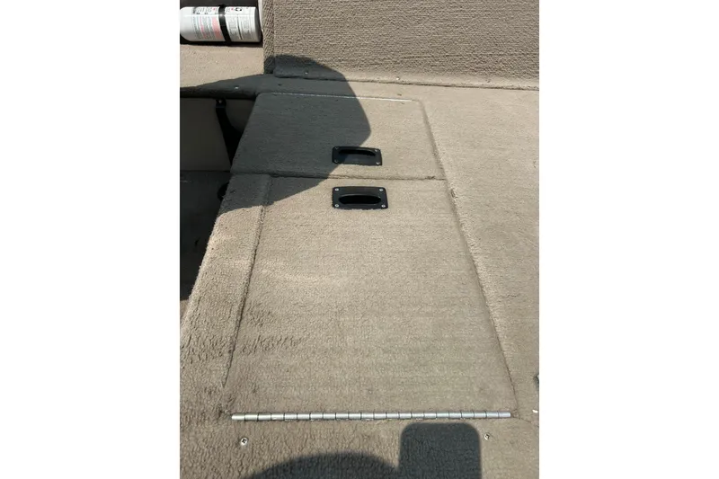 Slide: The Image of 2003 Crestliner 1850 Fish Hawk SC boat interior with carpeted storage compartments. - 30