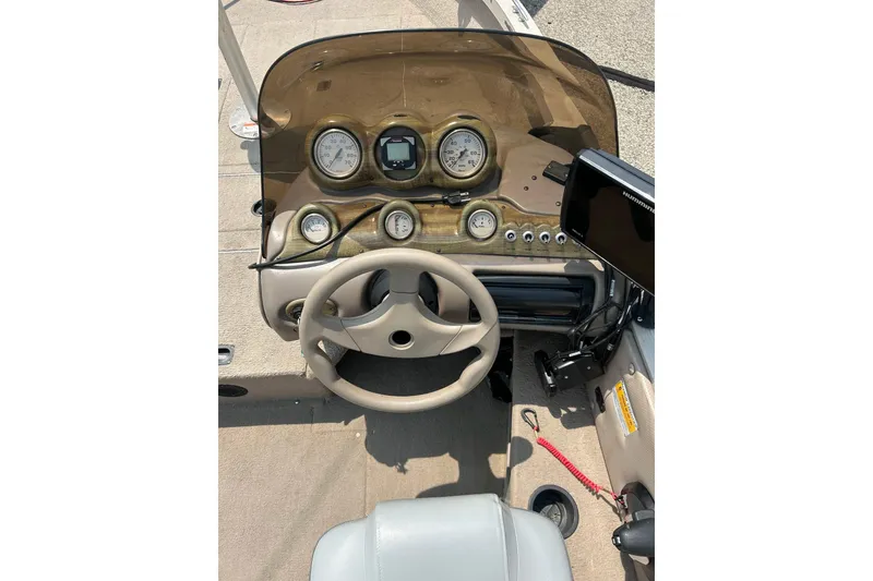 Slide: The Image of 2003 Crestliner 1850 Fish Hawk SC dashboard with steering wheel and gauges. - 32