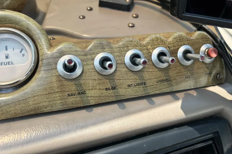 Slide: The Image of Dashboard of 2003 Crestliner 1850 Fish Hawk SC with fuel gauge and toggle switches. - 36