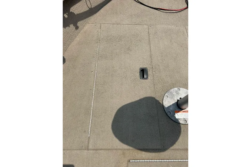 Slide: The Image of 2003 Crestliner 1850 Fish Hawk SC boat deck with storage compartment and seat base. - 9