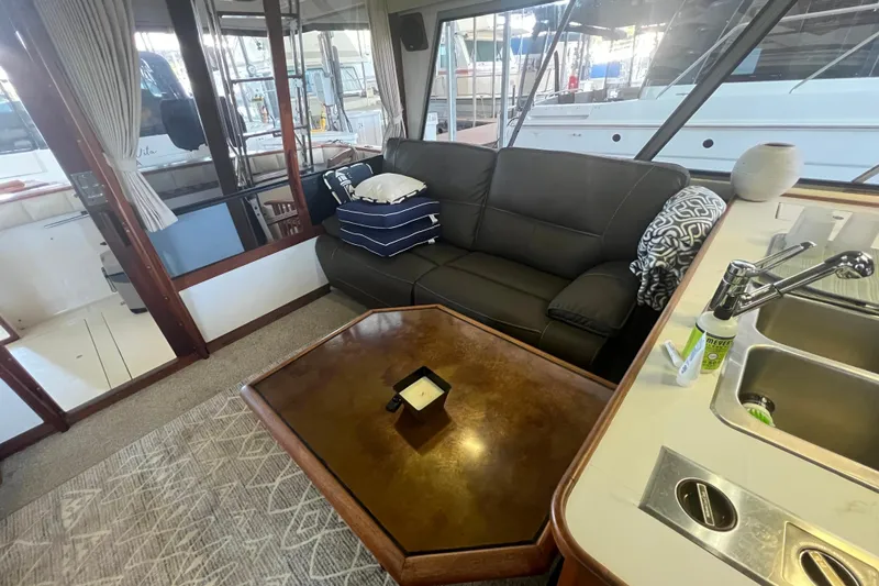 Slide: The Image of Interior of 1986 Bayliner 4550 Motoryacht with sofa, table, and kitchenette. - 16