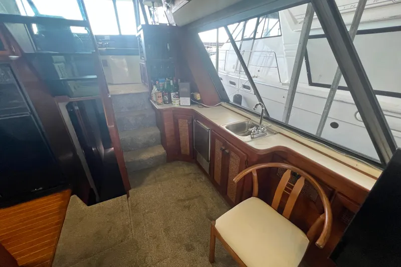 Slide: The Image of Interior of 1986 Bayliner 4550 Motoryacht with kitchenette and seating area. - 19