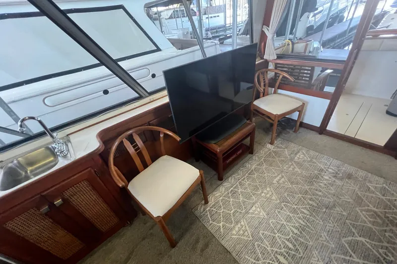 Slide: The Image of Interior of 1986 Bayliner 4550 Motoryacht with chairs, TV, and sink. - 20