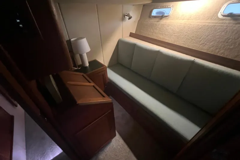 Slide: The Image of Interior of 1986 Bayliner 4550 Motoryacht with sofa, lamp, and porthole windows. - 28