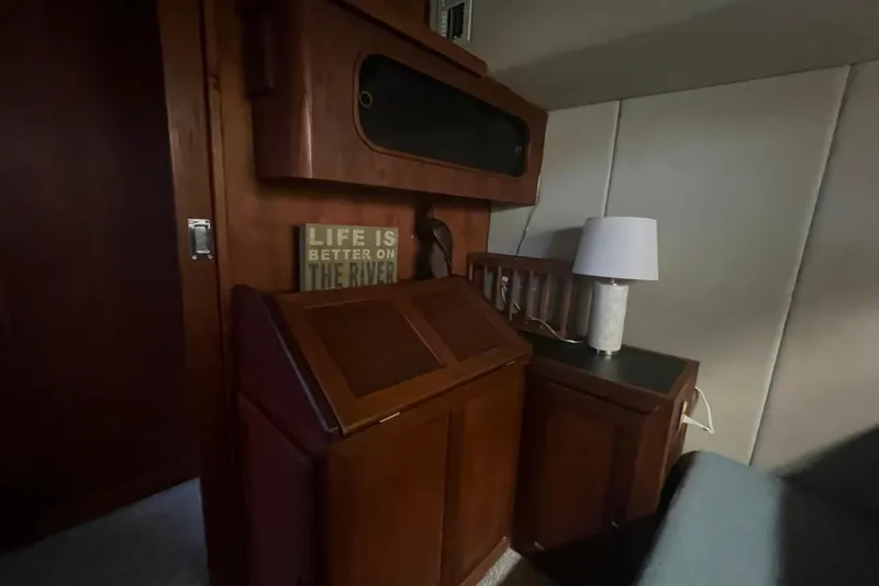 Slide: The Image of Interior of 1986 Bayliner 4550 Motoryacht with wooden cabinetry and lamp. - 30