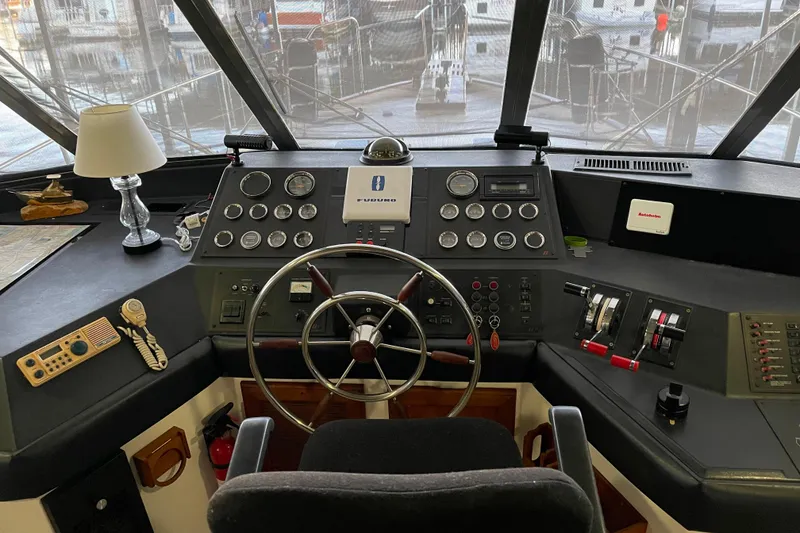 Slide: The Image of Cockpit of 1986 Bayliner 4550 Motoryacht with steering wheel and navigation instruments. - 42