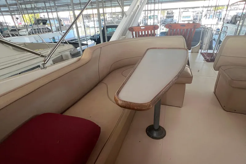 Slide: The Image of 1986 Bayliner 4550 Motoryacht interior with beige seating and wooden table. - 44