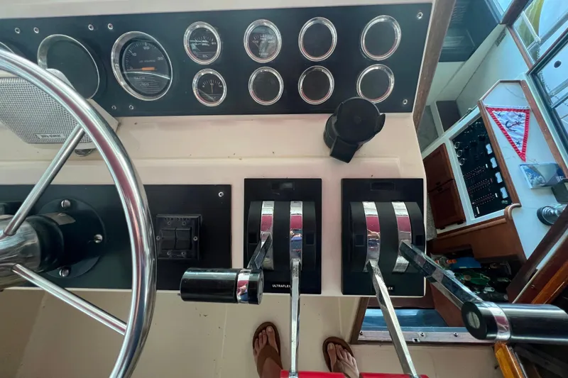 Slide: The Image of Control panel of a 1986 Bayliner 4550 Motoryacht with steering wheel and throttle levers. - 47