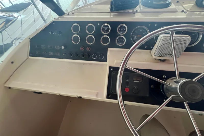 Slide: The Image of Control panel of 1986 Bayliner 4550 Motoryacht with steering wheel and gauges. - 48