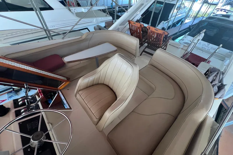 Slide: The Image of 1986 Bayliner 4550 Motoryacht interior with beige seating and steering wheel. - 49